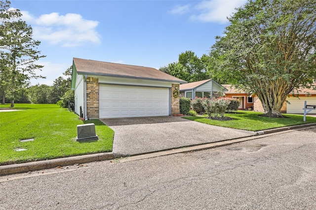 12121 Maverick Dr, Willis, TX 77378 - view of front of house featuring a front lawn, driveway, brick siding, and a garage