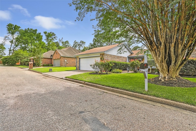 12121 Maverick Dr, Willis, TX 77378 - view of front of property featuring brick siding, a front yard, concrete driveway, and an attached garage