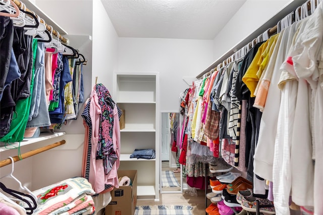 12121 Maverick Dr, Willis, TX 77378 - walk in closet featuring wood finished floors