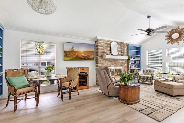 12121 Maverick Dr, Willis, TX 77378 - living area featuring light wood-style flooring, ceiling fan, and a fireplace