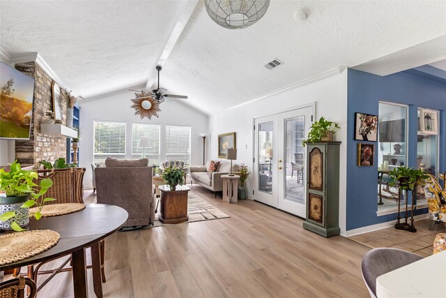12121 Maverick Dr, Willis, TX 77378 - living room featuring ceiling fan, light wood-style flooring, french doors, and a textured ceiling