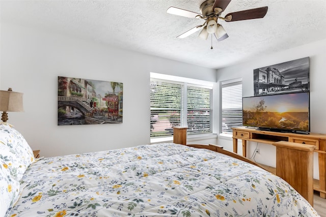 12121 Maverick Dr, Willis, TX 77378 - bedroom with a textured ceiling, wood finished floors, and ceiling fan