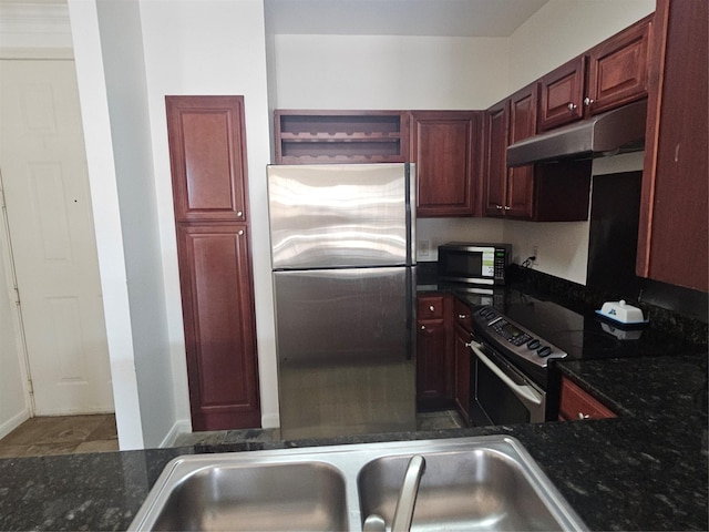 7575 Kirby Dr Unit 1104, Houston, TX 77030 - kitchen with stainless steel appliances, under cabinet range hood, open shelves, reddish brown cabinets, and dark stone countertops