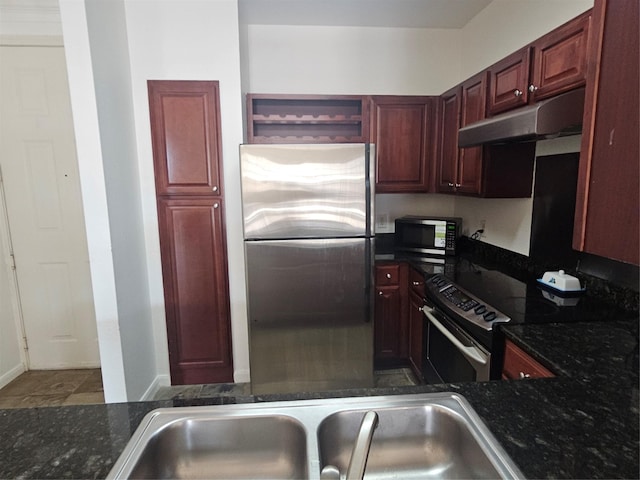 7575 Kirby Dr Unit 1104, Houston, TX 77030 - kitchen featuring appliances with stainless steel finishes, under cabinet range hood, open shelves, reddish brown cabinets, and dark stone countertops