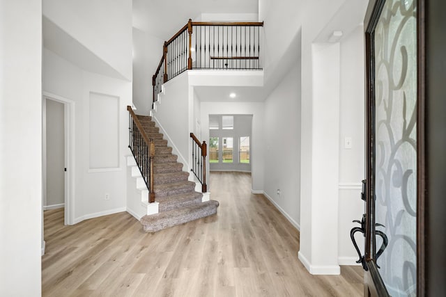 9114 Memorial Hills Dr, Spring, TX 77379 - foyer entrance featuring stairs, light wood finished floors, baseboards, and a towering ceiling