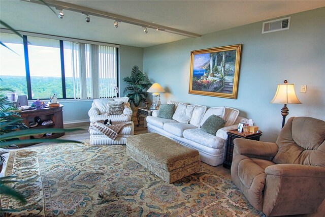 14655 Champion Forest Dr Unit 1102, Houston, TX 77069 - living area with wood finished floors, track lighting, and baseboards