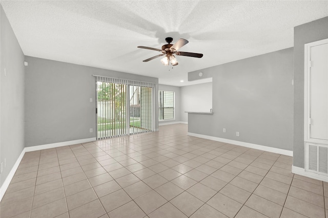 8385 Sands Point Dr Unit 5, Houston, TX 77036 - empty room featuring ceiling fan, a textured ceiling, baseboards, and light tile patterned flooring