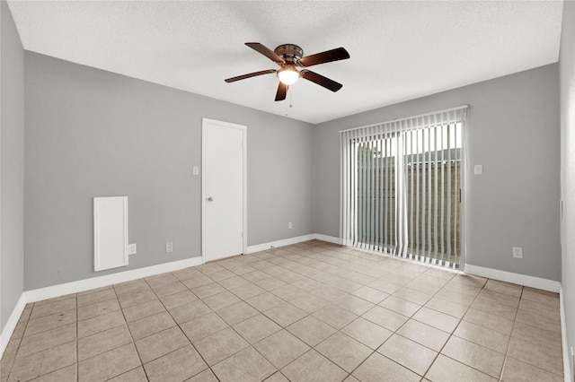 8385 Sands Point Dr Unit 5, Houston, TX 77036 - spare room featuring ceiling fan, light tile patterned floors, a textured ceiling, and baseboards