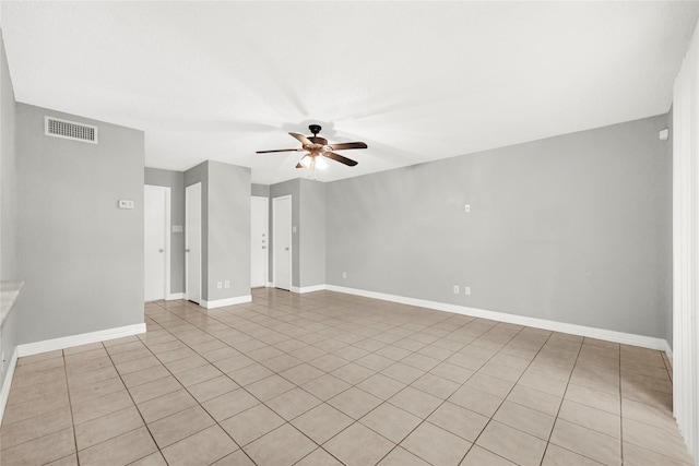 8385 Sands Point Dr Unit 5, Houston, TX 77036 - empty room featuring a ceiling fan, light tile patterned flooring, and baseboards