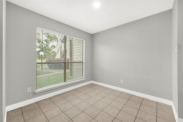 8385 Sands Point Dr Unit 5, Houston, TX 77036 - unfurnished room featuring a textured ceiling, light tile patterned floors, and baseboards