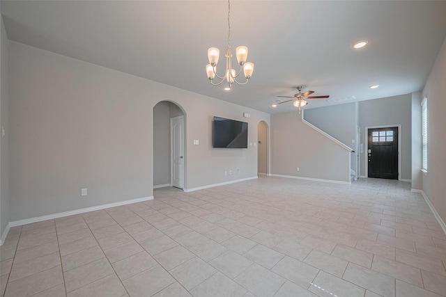 31630 Heguy Pass, Fulshear, TX 77441 - unfurnished living room featuring arched walkways, ceiling fan, recessed lighting, light tile patterned floors, and a chandelier