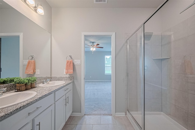 31630 Heguy Pass, Fulshear, TX 77441 - bathroom with double vanity, a ceiling fan, a stall shower, tile patterned floors, and baseboards