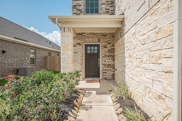 31630 Heguy Pass, Fulshear, TX 77441 - doorway to property featuring central AC, stone siding, and brick siding