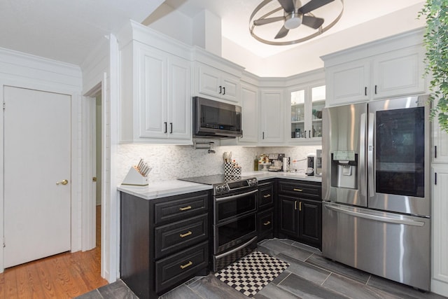 6840 County Road 659, Brazoria, TX 77422 - kitchen featuring appliances with stainless steel finishes, white cabinetry, dark cabinets, and a ceiling fan