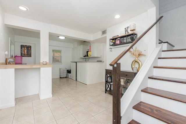 6840 County Road 659, Brazoria, TX 77422 - kitchen featuring light tile patterned floors, recessed lighting, white cabinetry, and light countertops