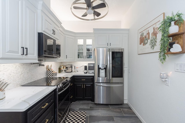6840 County Road 659, Brazoria, TX 77422 - kitchen featuring stainless steel fridge, electric stove, a ceiling fan, white cabinets, and dark cabinets