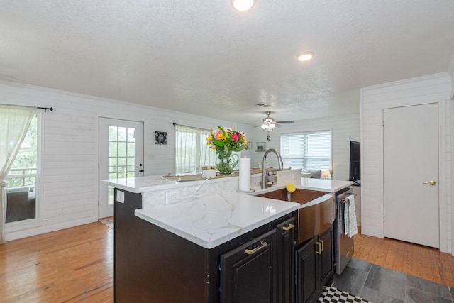 6840 County Road 659, Brazoria, TX 77422 - kitchen with a sink, healthy amount of natural light, a kitchen island with sink, dishwasher, and a textured ceiling