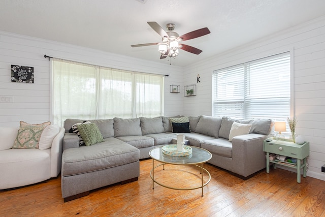 6840 County Road 659, Brazoria, TX 77422 - living area with wooden walls, light wood finished floors, and a ceiling fan