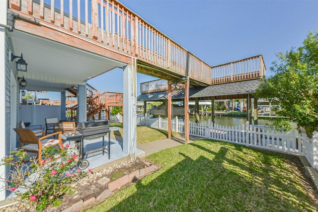 1236 Sailfish St, Bayou Vista, TX 77563 - view of yard featuring stairs, a patio area, and a deck with water view