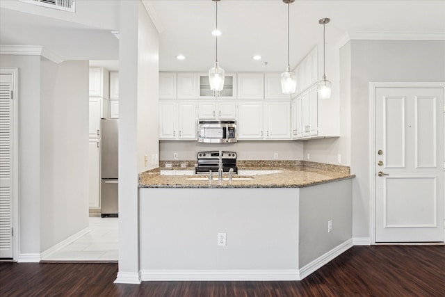 2111 Welch St Unit A123, Houston, TX 77019 - kitchen with stainless steel appliances, wood finished floors, light stone counters, baseboards, and white cabinetry