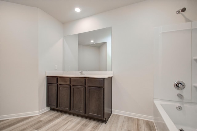 10699 Lost Maples Dr, Cleveland, TX 77328 - full bathroom featuring vanity, wood finished floors, baseboards, and bathtub / shower combination