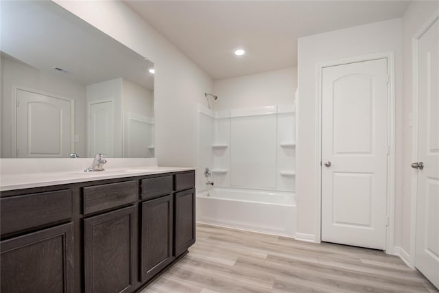 10699 Lost Maples Dr, Cleveland, TX 77328 - full bathroom featuring vanity, shower / bath combination, wood finished floors, and recessed lighting