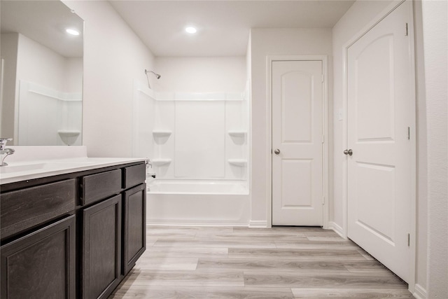 10699 Lost Maples Dr, Cleveland, TX 77328 - bathroom with vanity, shower / bath combination, wood finished floors, and recessed lighting