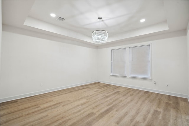 5847 Southington St, Houston, TX 77033 - unfurnished room featuring a raised ceiling, a chandelier, light wood finished floors, and recessed lighting