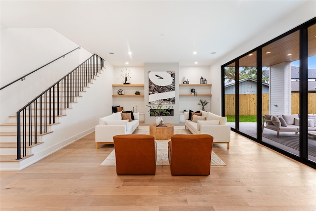 1741 Chippendale Rd, Houston, TX 77018 - living area with stairway, light wood-type flooring, and a wall of windows