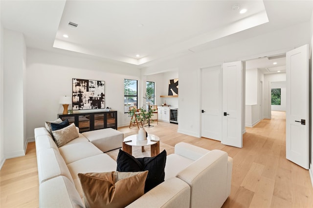1741 Chippendale Rd, Houston, TX 77018 - living room with a tray ceiling, light wood-type flooring, wine cooler, and recessed lighting