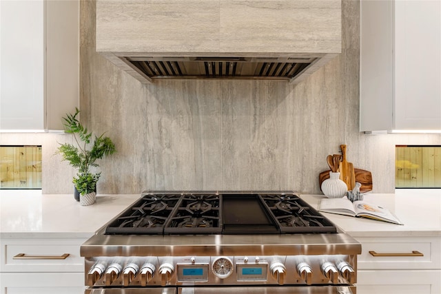 1741 Chippendale Rd, Houston, TX 77018 - kitchen featuring high end stove, extractor fan, light countertops, and white cabinetry