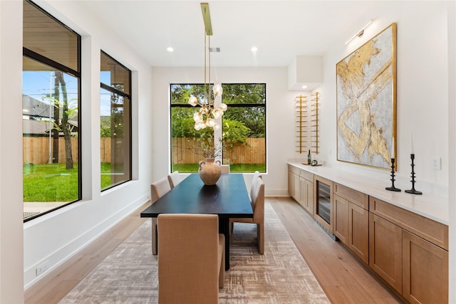 1741 Chippendale Rd, Houston, TX 77018 - dining room featuring wine cooler, a chandelier, light wood-style floors, and recessed lighting