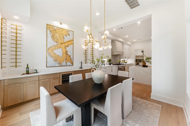1741 Chippendale Rd, Houston, TX 77018 - dining area with light wood-style flooring, recessed lighting, a chandelier, and wine cooler