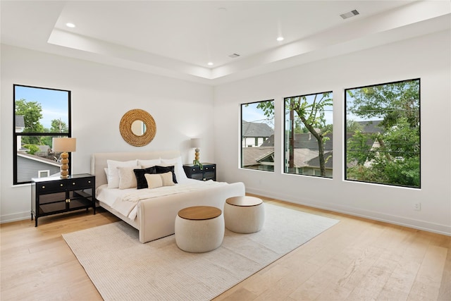 1741 Chippendale Rd, Houston, TX 77018 - bedroom featuring multiple windows, a raised ceiling, light wood-style floors, and recessed lighting