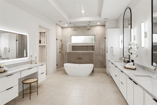 1741 Chippendale Rd, Houston, TX 77018 - bathroom featuring a shower stall, double vanity, a soaking tub, a tray ceiling, and tile patterned flooring
