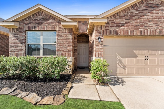 11375 Dawn Beach Ln, Conroe, TX 77304 - property entrance with brick siding, a garage, and concrete driveway