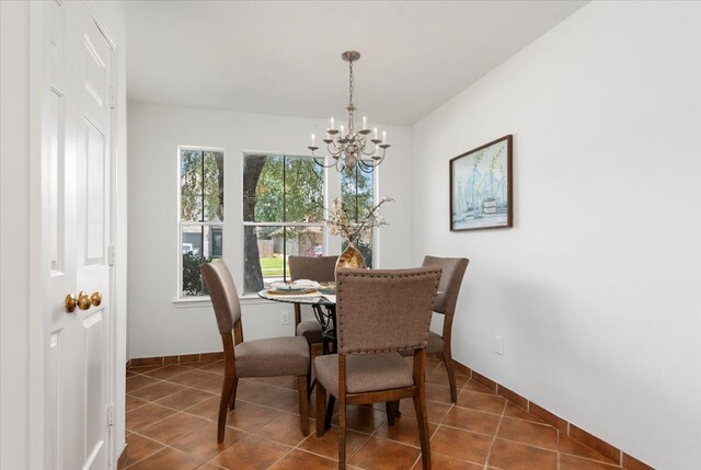 8702 Cold Lake Dr, Houston, TX 77088 - dining space with a chandelier, dark tile patterned flooring, and baseboards