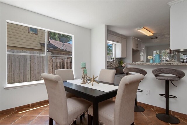 8702 Cold Lake Dr, Houston, TX 77088 - dining space with tile patterned floors and baseboards