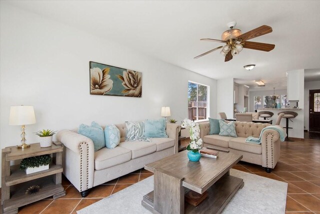 8702 Cold Lake Dr, Houston, TX 77088 - living area with dark tile patterned floors and a ceiling fan