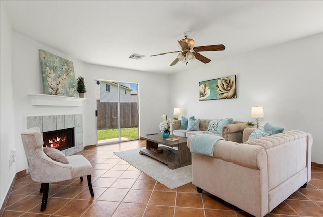 8702 Cold Lake Dr, Houston, TX 77088 - living room with tile patterned flooring, ceiling fan, and a tile fireplace