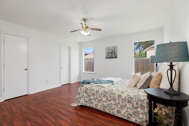 8702 Cold Lake Dr, Houston, TX 77088 - bedroom with multiple windows, wood finished floors, ceiling fan, and baseboards