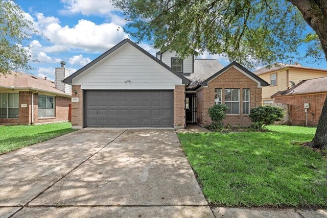 8702 Cold Lake Dr, Houston, TX 77088 - view of front of property with brick siding, an attached garage, a front lawn, and driveway