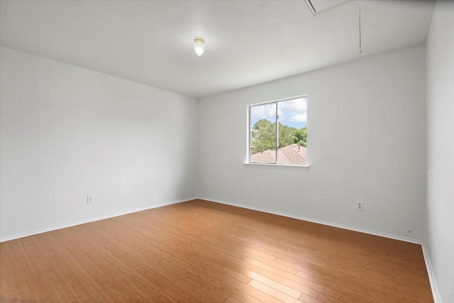 8702 Cold Lake Dr, Houston, TX 77088 - unfurnished room featuring attic access, wood finished floors, and baseboards