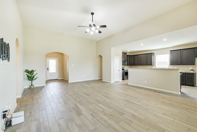 22303 Bauer Garden Dr, Hockley, TX 77447 - unfurnished living room with arched walkways, healthy amount of natural light, a ceiling fan, light wood-type flooring, and recessed lighting