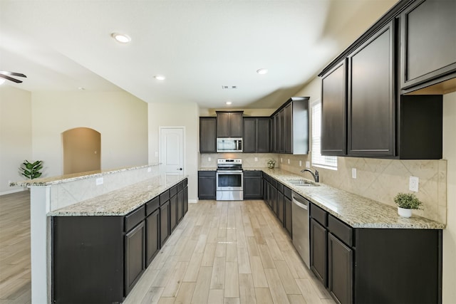 22303 Bauer Garden Dr, Hockley, TX 77447 - kitchen with stainless steel appliances, a kitchen island, light wood-type flooring, a sink, and recessed lighting