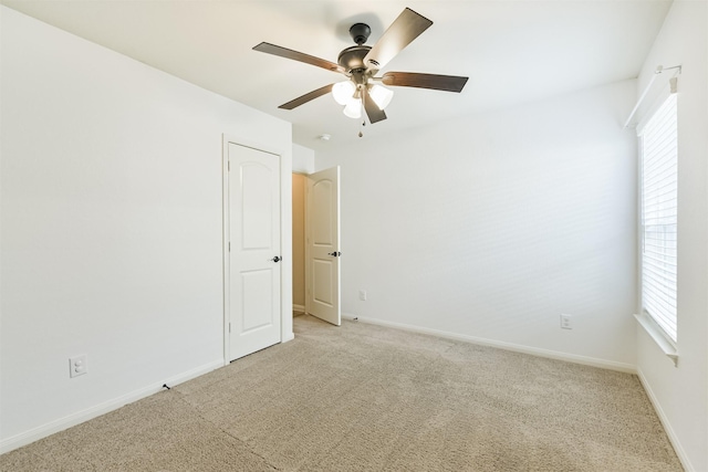 22303 Bauer Garden Dr, Hockley, TX 77447 - empty room with light colored carpet, a ceiling fan, plenty of natural light, and baseboards