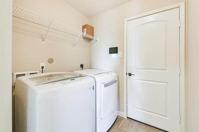 22303 Bauer Garden Dr, Hockley, TX 77447 - laundry area with washer and dryer and light wood-style floors
