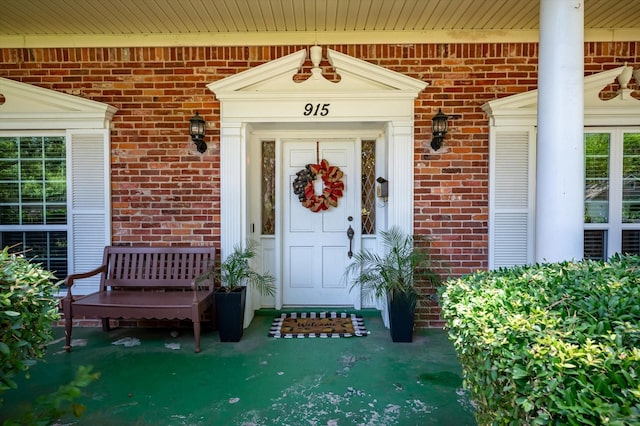 915 Timber Cove Dr, Seabrook, TX 77586 - view of exterior entry featuring brick siding and a porch