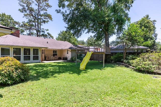 915 Timber Cove Dr, Seabrook, TX 77586 - view of green lawn featuring a playground and a patio