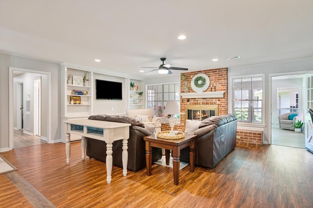 915 Timber Cove Dr, Seabrook, TX 77586 - living area with a ceiling fan, wood finished floors, a brick fireplace, baseboards, and recessed lighting